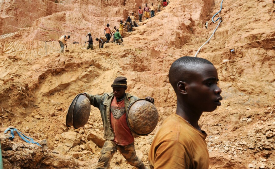 Workers dig at a gold mine in Chudja, near Bunia, northeastern Congo. The conflict in the Congo has often been linked to a struggle for control over its minerals resources.