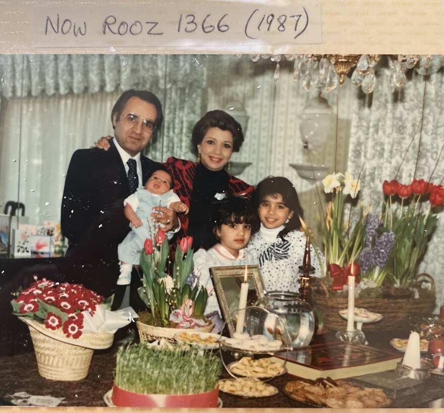 In a page from an old family photo album, Susie Ghahremani is shown with her siblings, mother Zohreh and her father in 1987.