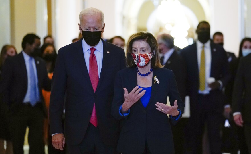President Biden walks with House Speaker Nancy Pelosi on Capitol Hill on Friday after attending a meeting with the House Democratic Caucus to try to resolve an impasse around the bipartisan infrastructure bill.