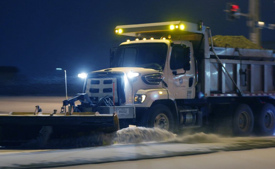 On the road again: This plow was at work on Sunday in Lawrence, Kan. The storm that hit there has spread east.