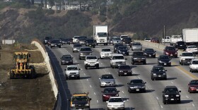 This file photo from October 2010 shows CalTrans, left, working along the 405 Freeway in Los Angeles.