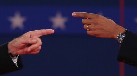 Republican presidential candidate Mitt Romney (L) and U.S. President Barack Obama talk to each other during a town hall style debate at Hofstra University October 16, 2012 in Hempstead, New York. During the second of three presidential debates, the candidates fielded questions from audience members on a wide variety of issues.