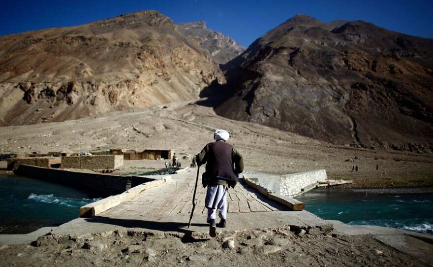 A man walks across a bridge over the Anjaman River in Afghanistan's Badakhshan province in August 2009.