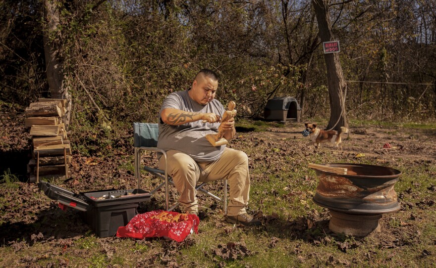 Madison Hye Long (Eastern Band of the Cherokee Indians) is a North Carolina-based photographer inspired by landscape artists and painters throughout history. From the series <em>Contemporary Artisans Defining Cherokee Culture</em>, this photo of Eastern Cherokee woodcarver Monk Walkingstick was made on the Qualla Boundary, home of the Eastern Cherokee, in the Great Smoky Mountains.