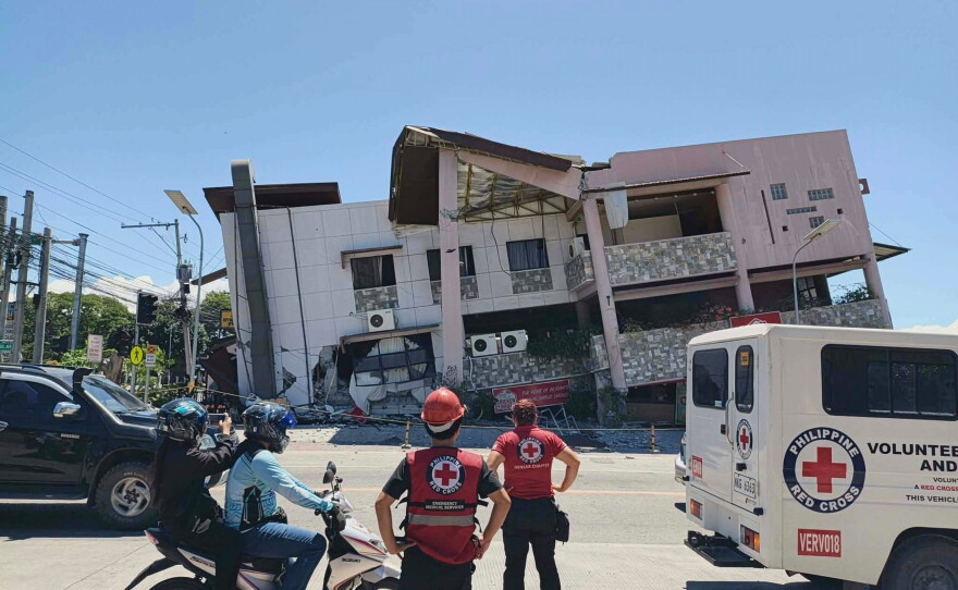 In this photo provided by the Philippine Red Cross, rescuers inspect the damage after an earthquake in General Santos, Philippines, Monday, June 8, 2026.