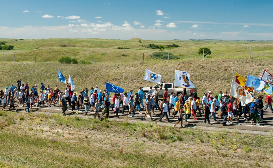 Native American protesters march from an encampment on the banks of the Cannonball River to a nearby construction site for the Dakota Access Pipeline to perform a daily prayer ceremony.