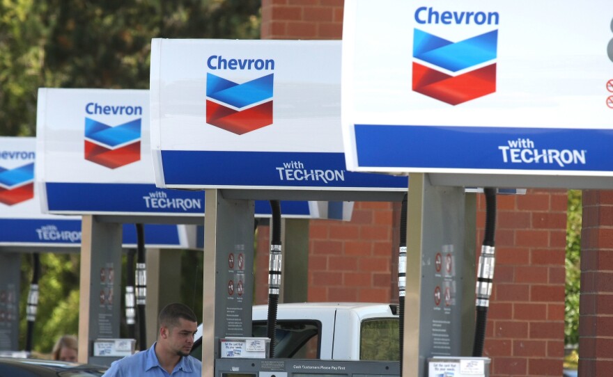 A Chevron customer pumps gas into his car in 2009 in Greenbrae, Calif. Chevron is acquiring Anadarko Petroleum for $33 billion in cash and stock.