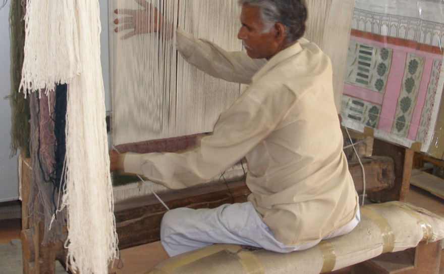 No special chair required: A man in Rajasthan, India, sits at his loom, weaving for hours each day with exemplary posture. He untucks his pelvis and elongates his spine.