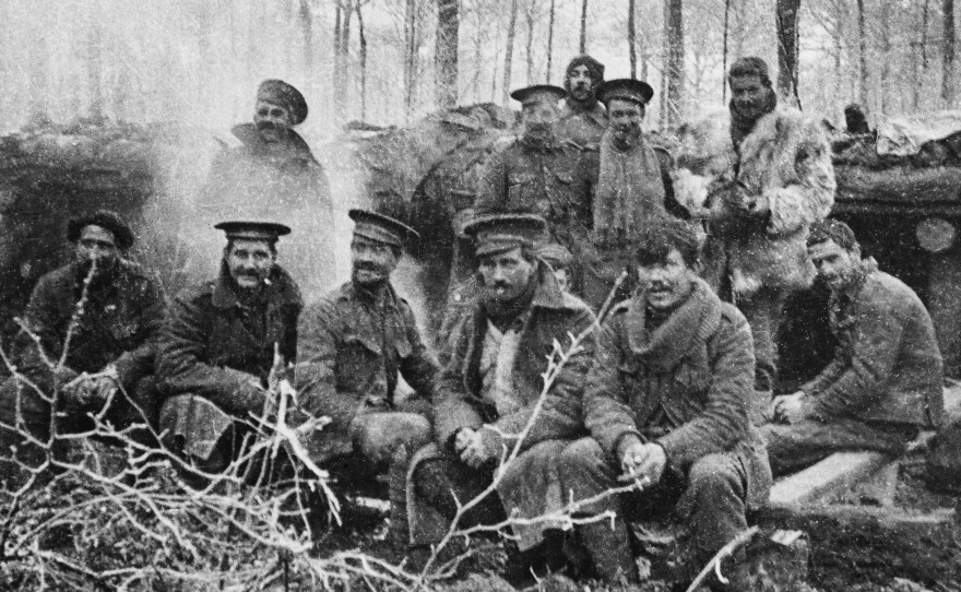 Group of Britain's 1st Battalion London Rifle Brigade just after dinner, at Ploegsteert Wood, Belgium, on Christmas 1914.