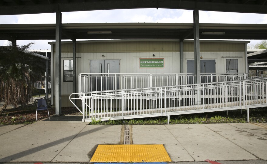 Carver Prep is housed in a small compound of temporary trailers with covered walkways in between. A new school building is under construction next door.