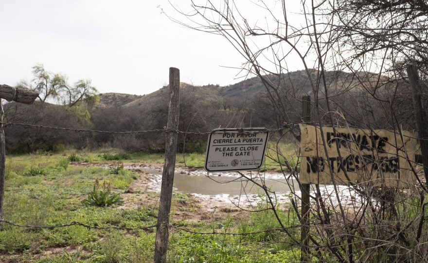 A fence acts as a cattle guard on ranchland near the U.S.-Mexico border.