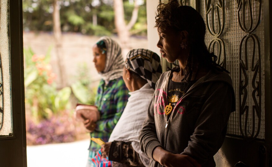 A woman waits for a family planning consultation at the Family Guidance Association's Model Sexual and Reproductive Health Clinic in Addis Adaba. She's wearing a necklace that displays a symbol of the Ethiopian Orthodox church.