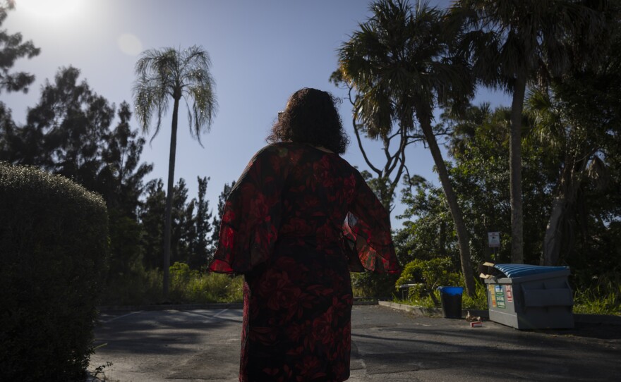 A woman who drives migrants across the country poses for a portrait in Fort Myers, Fla., in February.