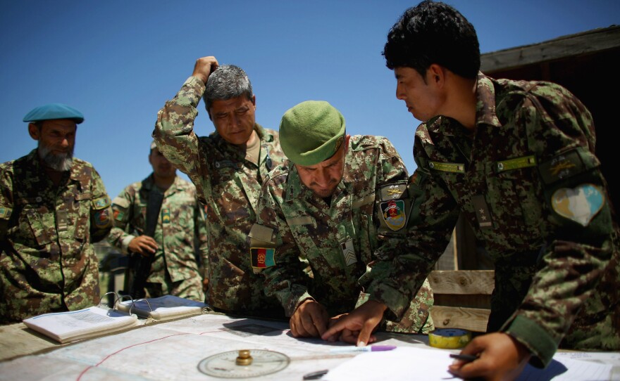 Afghan soldiers plot coordinates for their artillery strike against Taliban fighters in the hills of Nangahar Province.