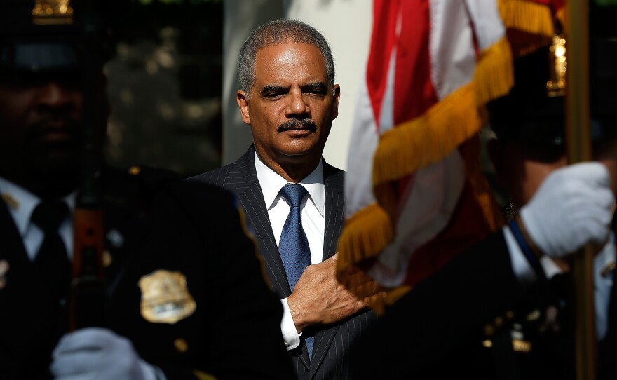 U.S. Attorney General Eric Holder attends a memorial service at the National Law Enforcement Memorial in Washington on the 13th anniversary of the Sept. 11th, 2001, attacks.