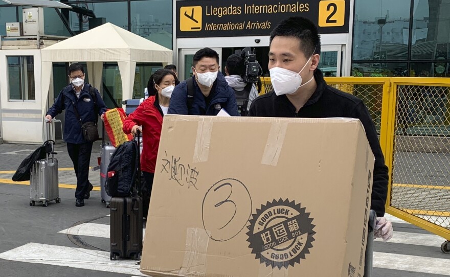 Members of a Chinese medical delegation arrive at the Lima airport with COVID vaccines for part of a clinical trial this fall. Peru hosted trials for several manufacturers in part to increase its chances of getting access to a successful inoculation.
