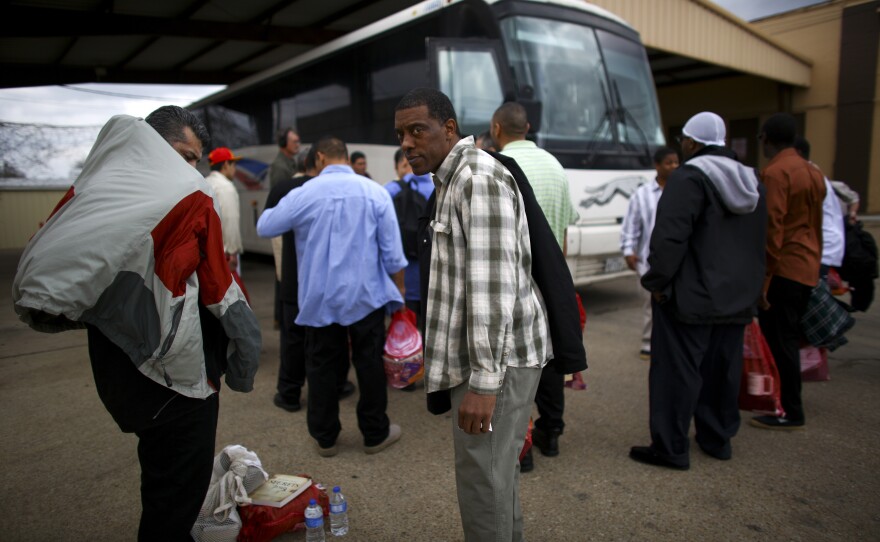 Shorah Greene (center) is ready to board the Greyhound to Houston after serving 12 months for a DWI conviction. He can't wait to see his grandson and resume his career as a licensed electrician.