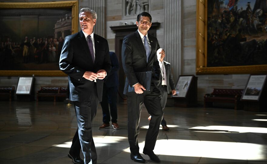 Former House Speaker Paul Ryan (right) and then-House Speaker Kevin McCarthy walk through the Capitol rotunda on May 17, 2023.