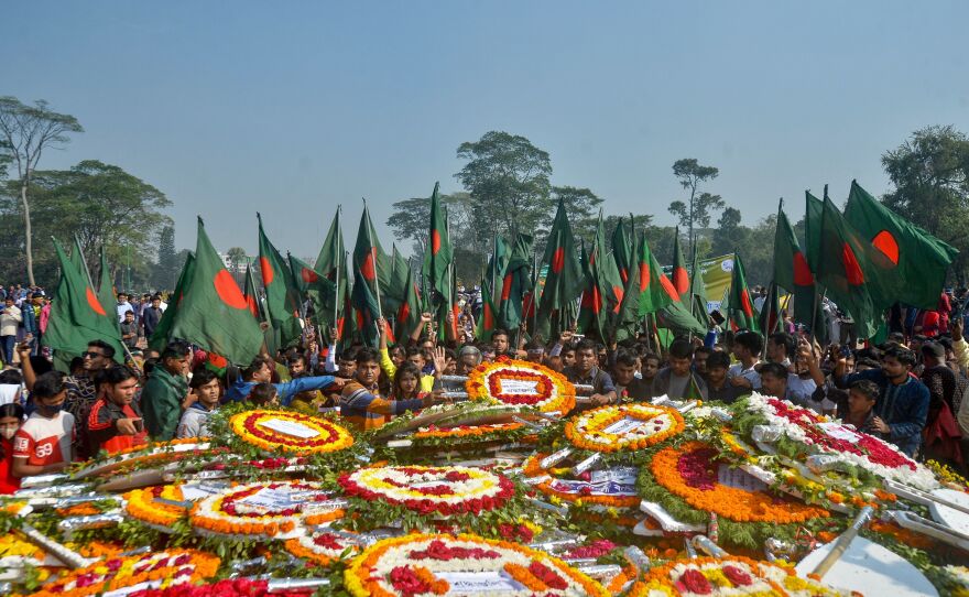 People gather to pay their respects at the 1971 independence war martyrs national memorial to celebrate the 50th Victory Day, which marks the end of a nine-month war of independence from Pakistan, in Savar, Bangladesh, on Thursday.