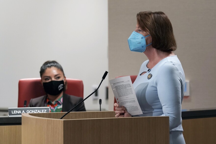State Sen. President Pro Tempore Toni Atkins, right, displays a copy of her proposed amendment to the state constitution that would protect the right to an abortion and contraceptives during a hearing on the measure in Sacramento, Calif., Tuesday, June 14, 2022. The bill was approved by two legislative committees. It must get a two-thirds vote in the state Assembly and Senate before June 30 to qualify for the November ballot.