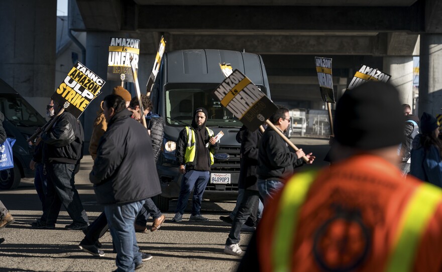 A union worker blocks an Amazon delivery truck from leaving the warehouse at Amazon Warehouse DCK6 in the Bayview District in San Francisco on Dec. 19, 2024. Amazon workers at multiple facilities across the United States went on strike to fight for a union contract.