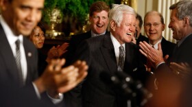 Kennedy receives a standing ovation from President Obama and others as he arrives at the White House's forum on health care reform.