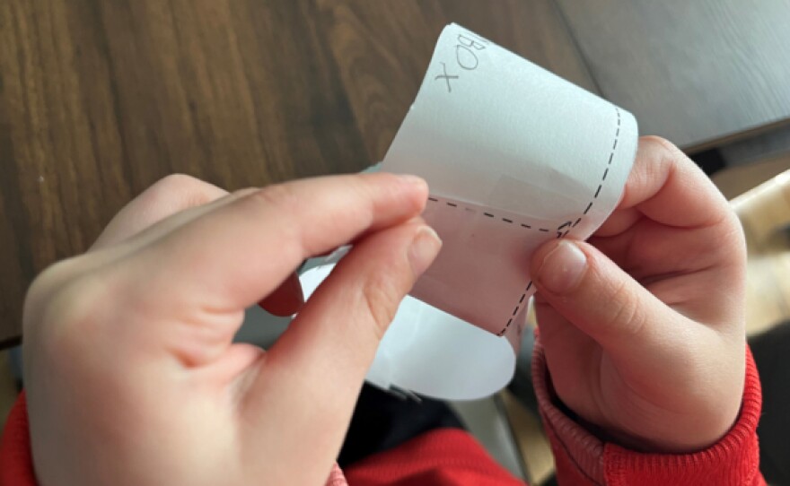 Child wraps his goal strip into a ring for the Donkey Hodie ring project in this undated photo.