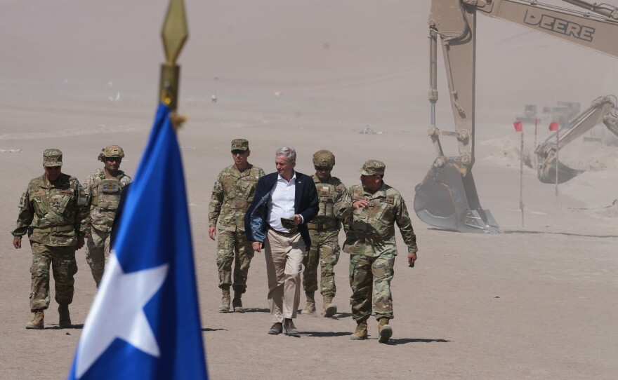 Chilean President Jose Antonio Kast walks past diggers along the northern border at the Chacalluta border crossing in Arica, Chile, March 2026.