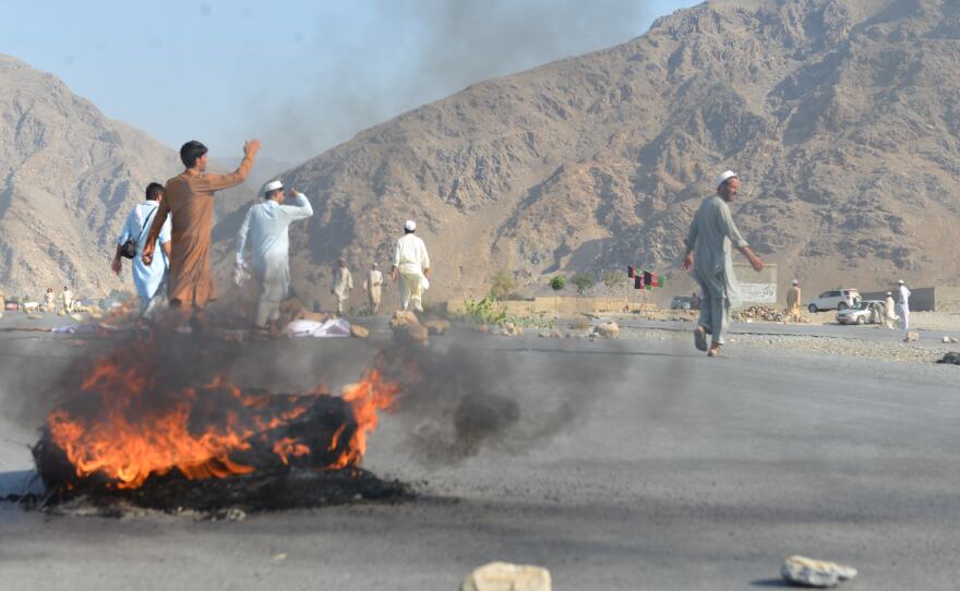Men shout slogans against terrorists after a suicide attack among the protesters in Momandara district of Nangarhar province, Afghanistan, on Tuesday.