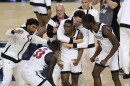 San Diego State guard Lamont Butler, center, celebrates with teammates after he hit the winning basket against Florida Atlantic during the second half of a Final Four game on Saturday.