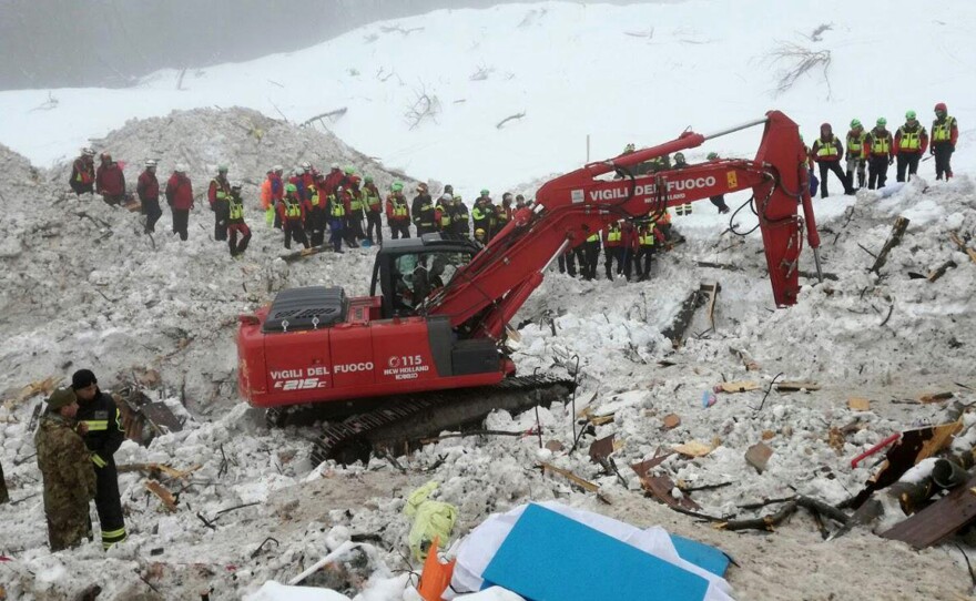 An excavator works at the site of the avalanche-buried Hotel Rigopiano, near Farindola, Italy.