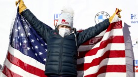 Bobsleigh pilot Kaillie Humphries of the United States celebrates on the podium after taking first place in the women's monobob race at the Bobsleigh and Skeleton World Championships in Altenberg, Germany, Feb.14, 2021.
