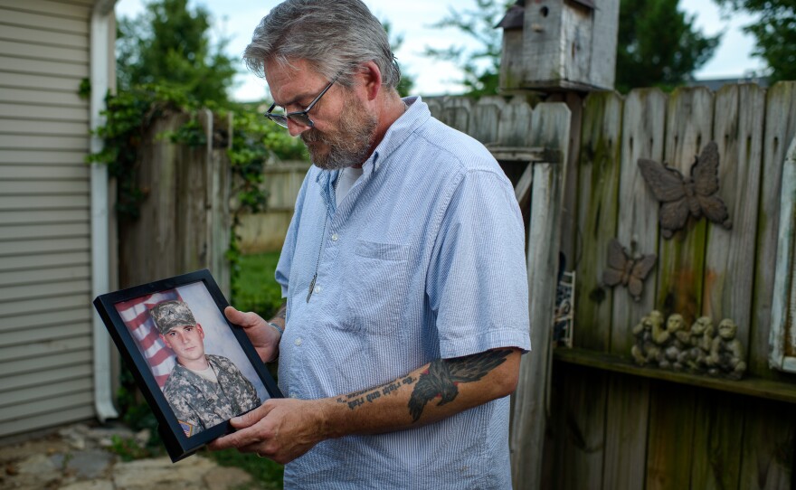 David Toombs holds a photo of his son, John, at his home in Murfreesboro, Tenn. Former Sgt. John Toombs developed a drug problem after he left the Army and was in a residential treatment program at the Murfreesboro Veterans Affairs center. In 2016, he killed himself on the VA campus.