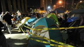 Yellow police tape surrounds tents at Occupy San Diego as protesters rally, on October 14, 2011. 