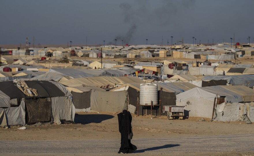 A woman walks in the al-Hol camp in northeastern Syria's Hasakeh province on Jan. 30. Tens of thousands of mostly women and children linked to the Islamic State group have been living here for years.
