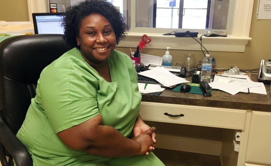 LaTasha Perry says she couldn't afford the health plan offered by the community health center where she works. But with a subsidized plan, she has insurance and money left over "to buy food for my kids."