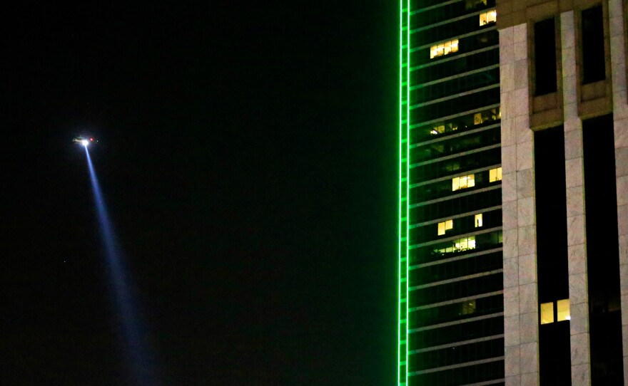 A Dallas police helicopter flies over the scene where several Dallas police officers were shot.