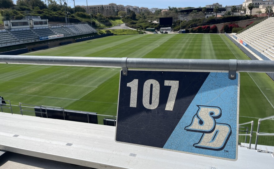 A University of San Diego stadium section sign hangs above the grassy sports field below, March 16, 2026.