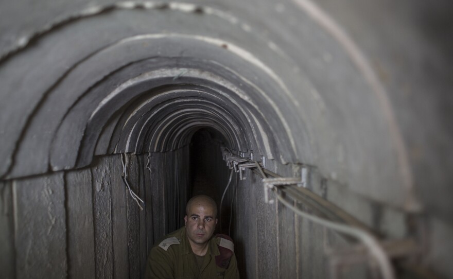 An Israeli soldier stands inside an underground tunnel built by Hamas militants leading from the Gaza Strip into Southern Israel. Israel says it has destroyed 32 similar tunnels so far in the nearly monthlong conflict.