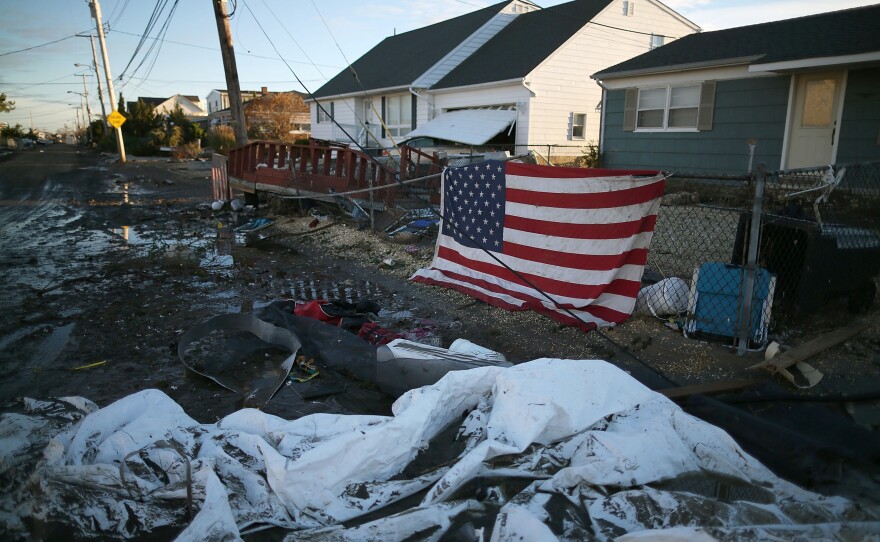 An American flag flies in front of a home damaged by Superstorm Sandy on Nov. 1, 2012, in Toms River, N.J.