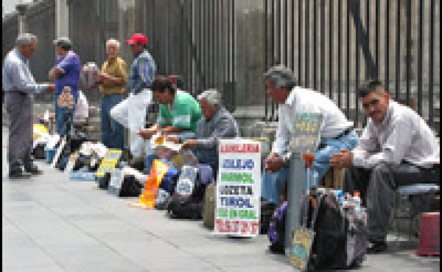 Unemployed construction workers in Mexico City gather every morning on the capital's central plaza, the Zocalo, in hopes of finding work as day laborers. Some have signs advertising their skills as plumbers, electricians and brick masons.