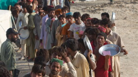 Flood victims line up for food distribution at a tented camp on August 21, 2010 in Sukkur , Pakistan. The country's agricultural heartland has been devastated, with rice, corn and wheat crops destroyed by floods.
