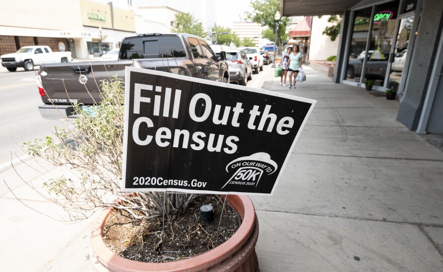 A sign promoting the 2020 census stands in a planter in Roswell, N.M. in August. A federal judge has ordered the Trump administration to continue holding back on wrapping up the 2020 census for now.