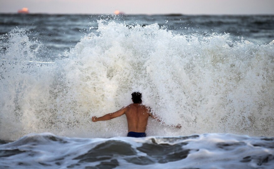 Body surfer Andrew Vanotteren, of Savannah, Ga., crashes into waves from Hurricane Florence, Wednesday, Sept., 12, 2018, on the south beach of Tybee Island, Ga. 