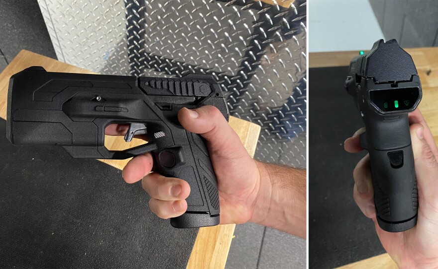 The version of the Biofire smart gun demonstrated for NPR. On the left, the fingerprint sensor can be seen on the gun grip. On the right, the facial recognition sensor can be seen on the back. The green lights indicate that the gun is unlocked.