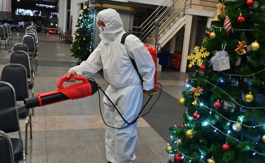 A worker wearing personal protective equipment disinfects the Holy Redeemer Church in Bangkok after a Christmas Eve mass. Thailand is one of many countries now seeing a surge in cases.