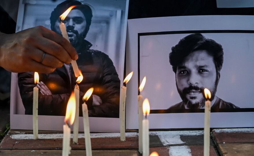 Candles are placed by journalists next to portraits of Danish Siddiqui as a tribute in Kolkata, India, on Friday, after the Pulitzer Prize-winning photographer with the Reuters news agency was killed covering fighting between Afghan security forces and the Taliban.