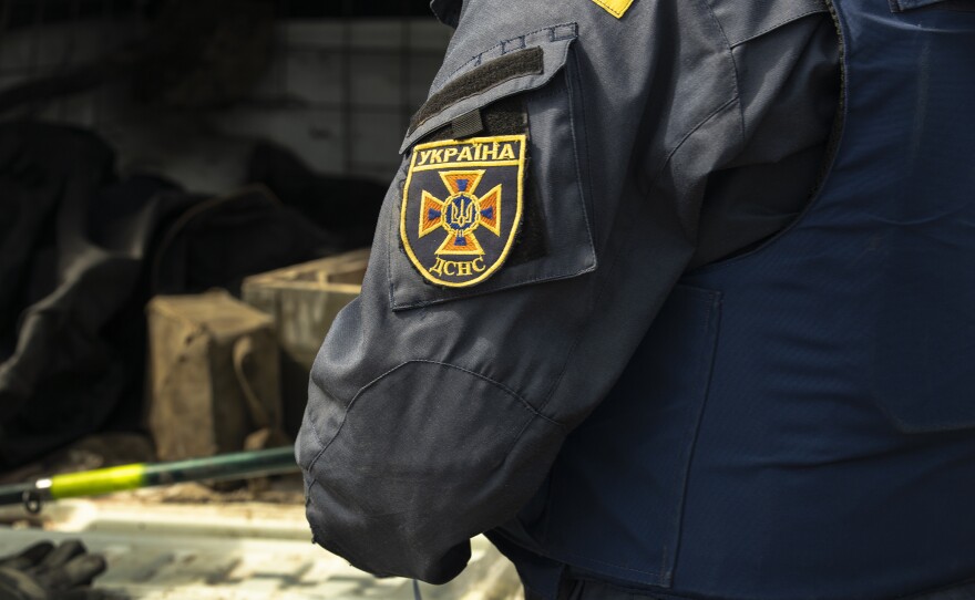 Maksim's State Emergency Service patch can be seen as he prepares to detonate another unexploded timed mine.