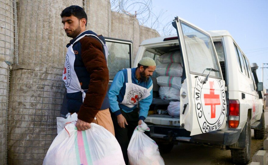 Two Red Cross workers prepare to distribute goods to detainees at a provincial prison in Afghanistan.