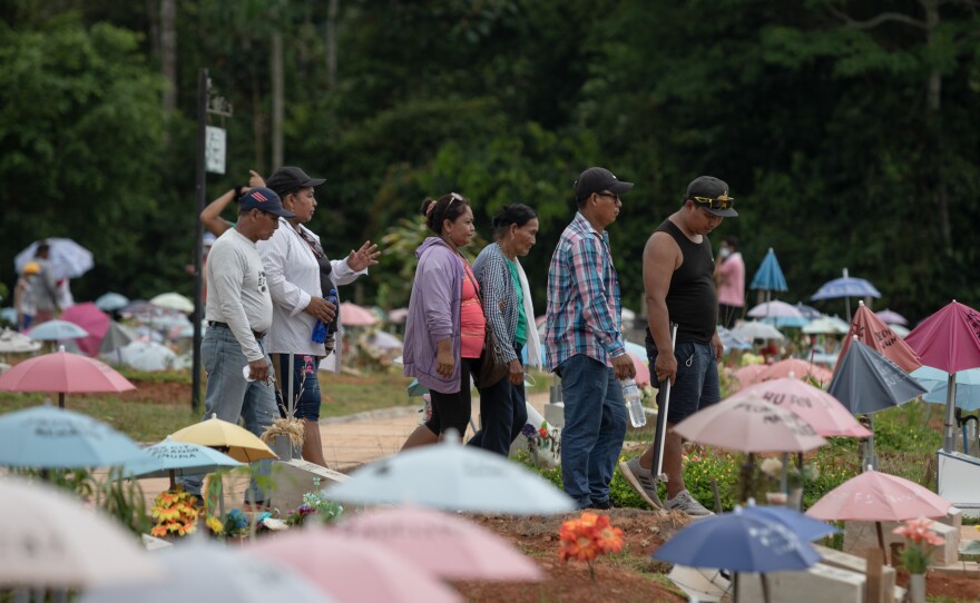 Ahuanari family visits the San Juan Bautista cemetery, a place where they would like to bury their mother after exhuming her from the common grave for the deceased by coronavirus in Iquitos, Peru.